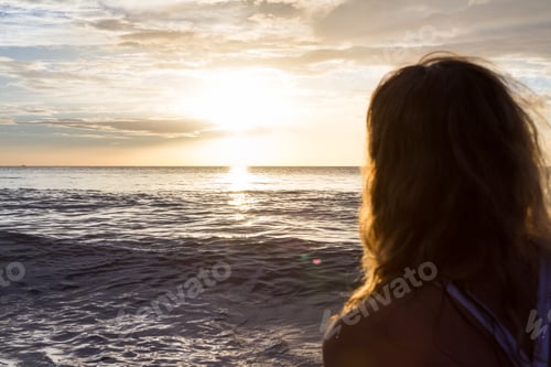 Preview: Concept Of The Back Of A Woman'S Hair Looking At The Sun Set Across The Pacific Ocean