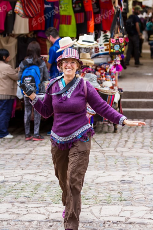 Preview: Pisac, Peru - May 15: Happy Tourist Walking On The Alleyways Of The Market Of Pisac Looking At The