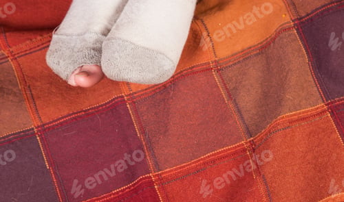 Preview: Worn Out Socks Dirty With A Hole And Toes Sticking Out Of One Of Them Over A Colorful Background