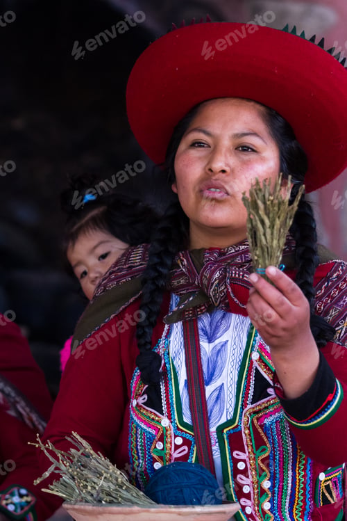 Preview: Chinchero Peru -May 18 : Native Cusquena Woman Dressed In Traditional Colorful Clothing Explaining