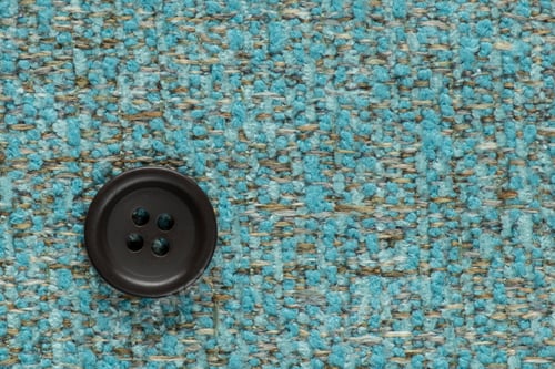 Preview: Clothes Sewing Button On A Turquoise Fabric Swatch Background
