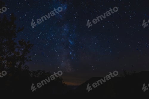 Preview: The Dark Night Sky Above The Austrian Alps Showing The Milky Way Glowing In The Blue Sky