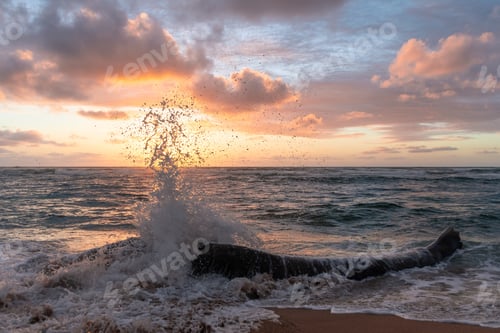 Preview: Big Waves Crashing On A Piece Of Driftwood On A Peaceful, Empty Beach With A Beautiful, Colorful