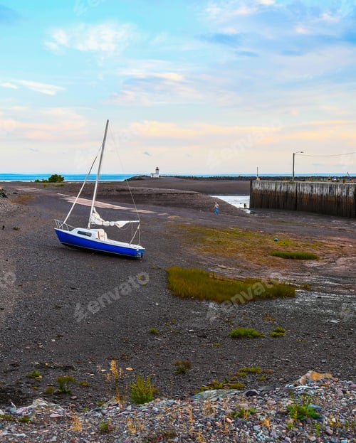 Preview: A View Of The Parrsboro Lighthouse In Nova Scotia, Canada With A Boat On The Bottom Of The Bay Of