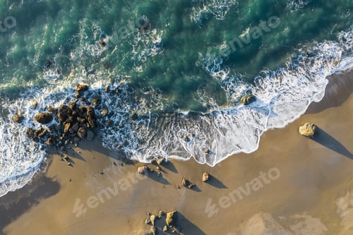 Preview: Beach Scene From Above With Colorful Waves Crashing On To A Group Of Rocks In The Oregon Coast