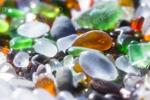 Preview: Close Up Of A Group Of Shiny Pieces Of Sea Glass On The Beach Using A Star Filter To Obtain A