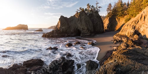 Preview: Beautiful Sunset In Secret Beach Oregon With A Soft Warm Glow On The Rocks And Evergreen Trees On