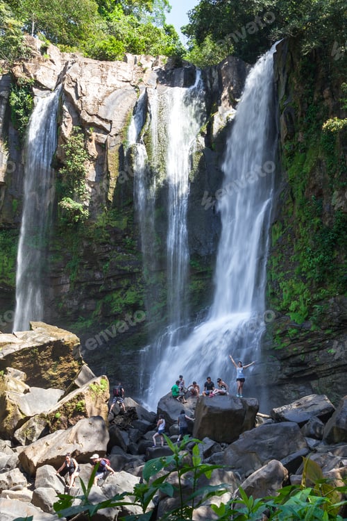 Preview: Nauyaca, Costa Rica - January 28: People Sitting On The Large Boulders At The Base Of The Falls