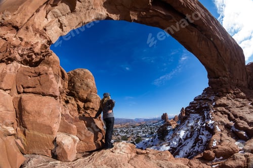 Preview: Woman Dressed In Full Winter Gear Enjoying The Panoramic View From North Window
