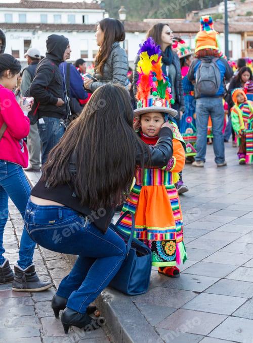 Preview: Cusco, Peru - May 13: Mother Helping Her Child With Her Colorful Headdress In A Religious