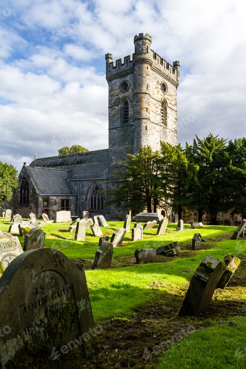 Preview: Culross, Scotland - September 16 2019: Headstones In The Cemetery With Culross Abbey In The