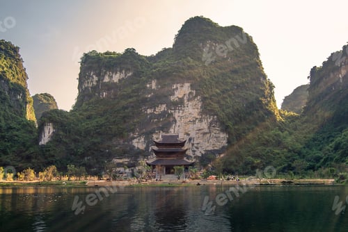 Preview: Old Sacred Temple In The Middle Of The River At Sunset With Limestine Cliffs In The Background