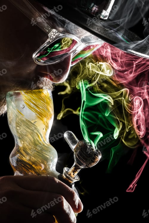 Preview: Studio Shoot With Model Simulating Smoking Pot Through A Bong In A Dark High Contrast Image