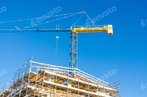 Preview: High-Rise Building Under Construction. The Site With Cranes Against Blue Sky