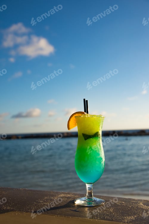 Preview: Colorfull Cocktail With Ocean View On Sandy Table