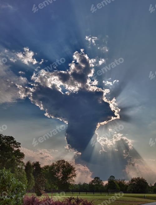 Preview: Hdr Shot Of A Tall Anvil Shaped Cloud Over Meadows With Sunrays