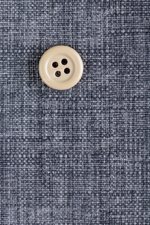 Preview: Clothes Sewing Button On A Gray Fabric Swatch Background
