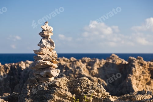 Preview: Pyramid Shaped Stack Of Rocks Balanced On The Edge Of Ocean