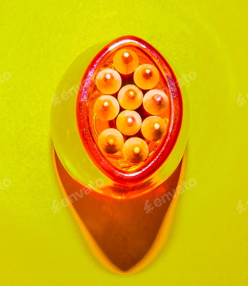 Preview: Shades Of Orange Colored Pencil Points In An Orange Glass Vase
