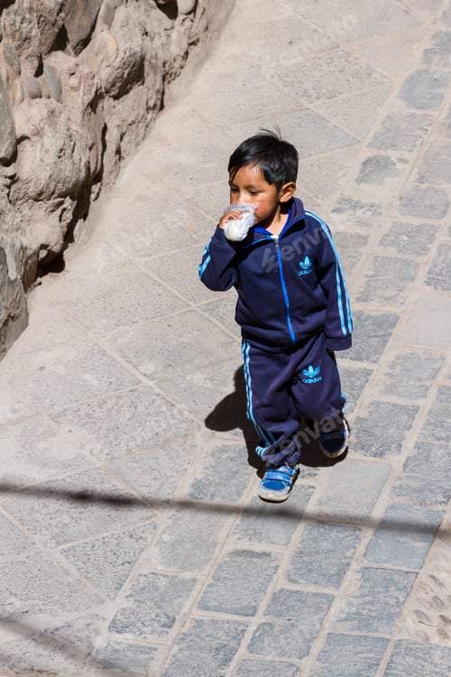Preview: Pisac, Peru - May 15: Young Boy Walking Dressed Up In Full Adidas Clothing In The Sacred Valley