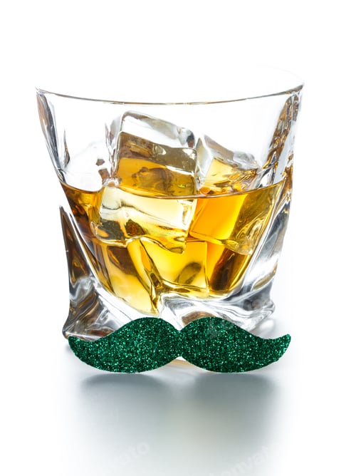 Preview: Close Up Fo A Glass Of Whiskey With A Green Mustache Isolated On A White Background As A Concept