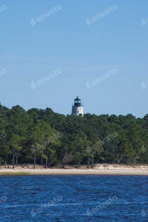 Preview: Lighthouse On The Bank With Trees Around It