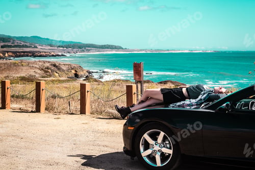 Preview: Photo Of Girl On Top Of Convertible At Half Moon Bay, California