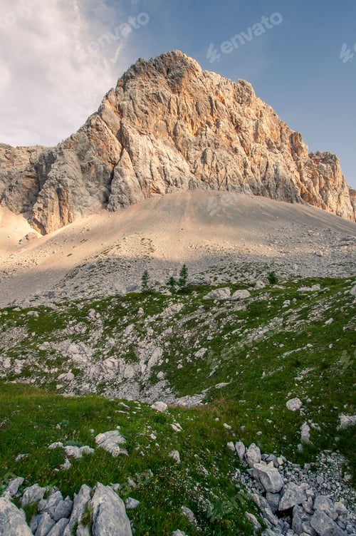 Preview: Portrait Photo Of A Valley With A Rocky Peak And Grass As The Sun Is Going Down On A Sunny