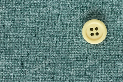 Preview: Clothes Sewing Button On A Turquoise Fabric Swatch Background