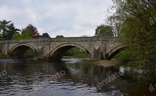 Preview: Unusual Stoen Bridge With Arches Over A River Way.