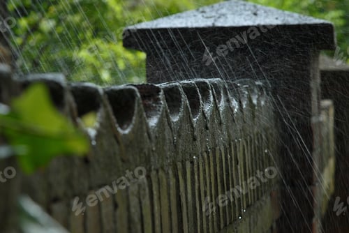 Preview: Detail Shot Of An Old Brick Wall Surrounding A Garden With Some Water From An Irrigation System