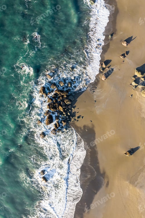 Preview: Beach Scene From Above With Colorful Waves Crashing On To A Group Of Rocks In The Oregon Coast