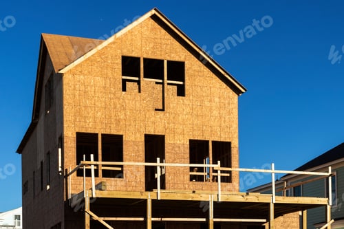 Aperçu: New House Construction Frame Against A Blue Sky