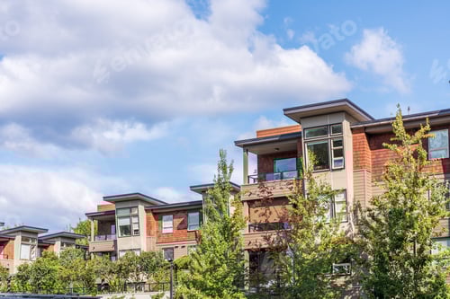 Preview: The Top Of An Apartment Building With Nice Windows And Colourfull Trees.