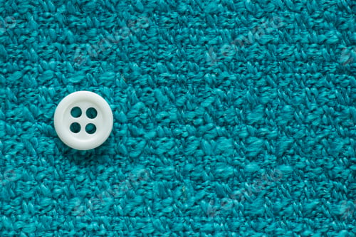 Preview: Clothes Sewing Button On A Turquoise Fabric Swatch Background