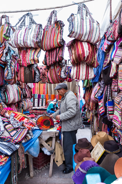 Preview: Pisac, Peru - May 15: Peruvian Man Selling Souvenirs Like Handbags And Hats At The Market In Pisac
