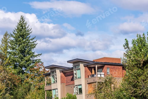 Aperçu: The Top Of An Apartment Building With Nice Windows And Colourfull Trees.