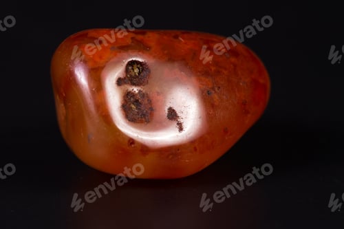 Preview: Close Up Of A Polished Piece Of Carnelian Isolated On A Black Background