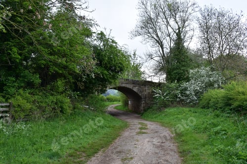 Preview: Dirt Pathway Passing Under A Curved Bridge In England.