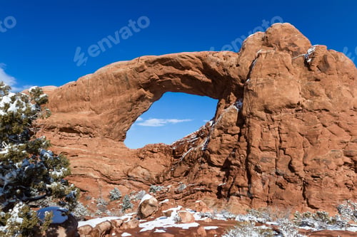 Preview: Snow Covered Ground With Beautiful Red Rock Features With A Blue Sky In Arches National Park