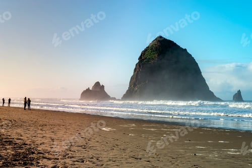 Preview: Oregon Coast Beach - Winter Tourists Walking In The Background Of The Famous Cannon Beach Haystack