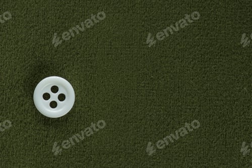 Preview: Clothes Sewing Button On A Green Fabric Swatch Background