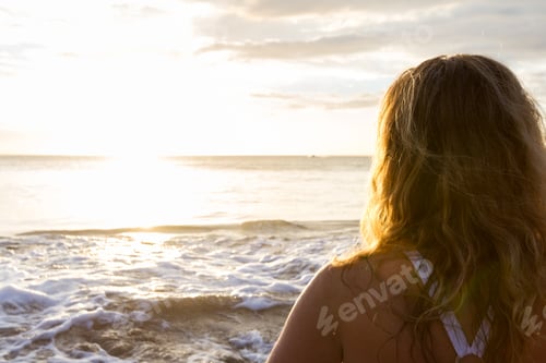 Preview: Concept Of The Back Of A Woman'S Hair Looking At The Sun Set Across The Pacific Ocean