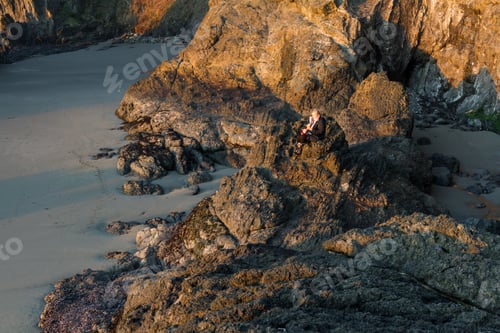 Preview: Woman Sitting The Rocky Shores South Of Secret Beach In The Oregon Coast With Her Small Dog And