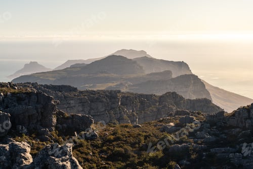 Preview: Landscape Photo Of A Rocky Summit With Hills And Rocks In The Horizon At Sunset. Shot In Table