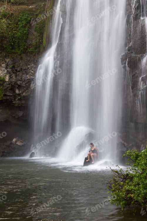 Preview: Llanos Del Cortez Waterfall In Costa Rica With A Person Standing At The Base To Show The Size Of