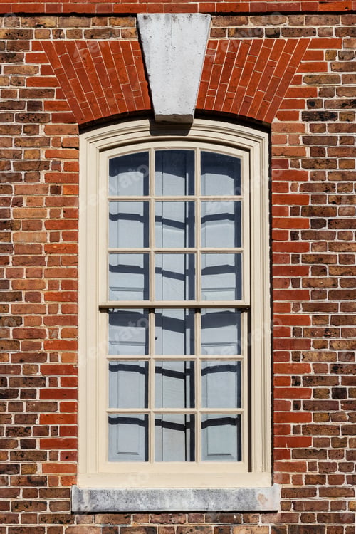 Preview: Old Wooden Window With Interior Shutters In A Brick Building