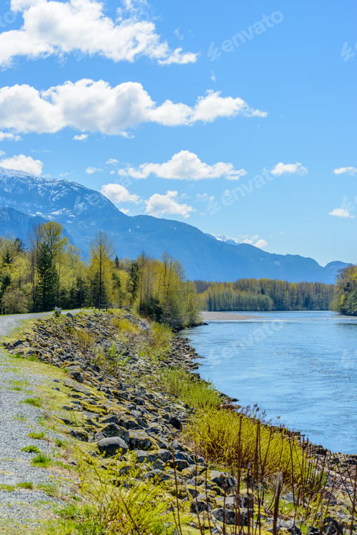 Preview: Majestic Mountain River In Winter Over Snow Mountains And Blue Sky In Vancouver, Canada.