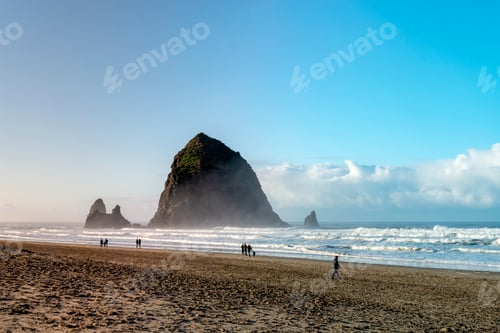 Preview: Oregon Coast Beach - Winter Tourists Walking In The Background Of The Famous Cannon Beach Haystack