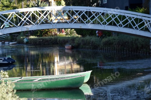 Preview: Rowboats And Beautiful Reflections In A Peaceful Canal With A Bridge